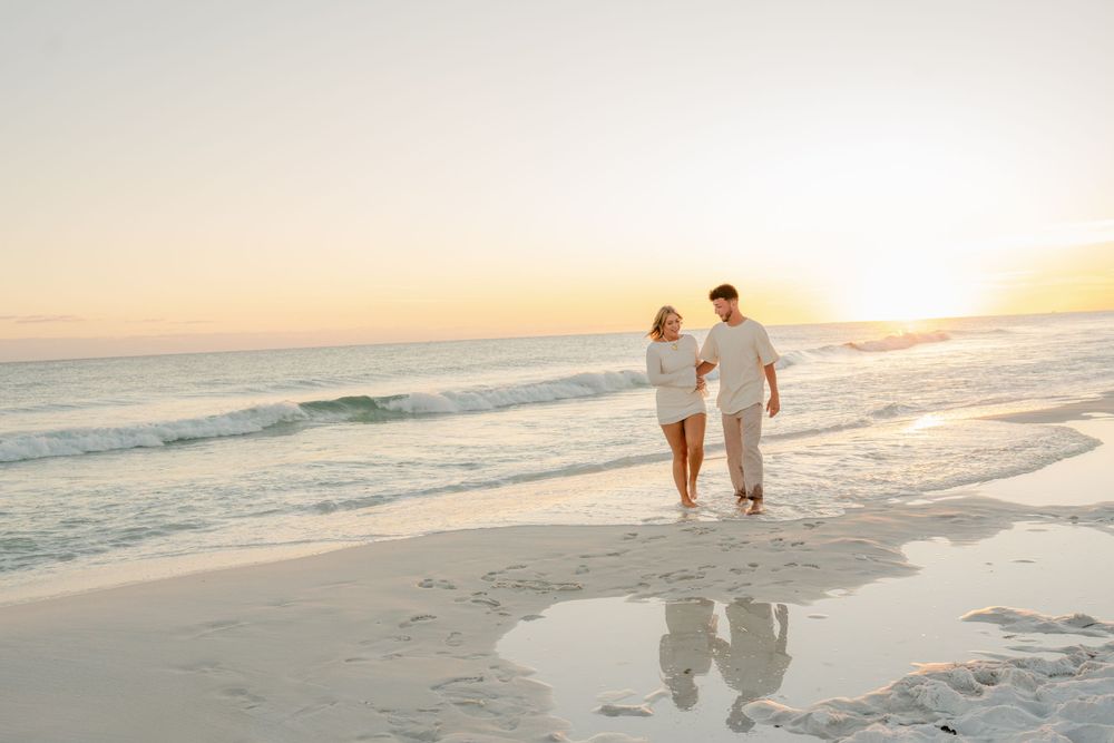 A romantic sunset beach walk with waves crashing in the background.