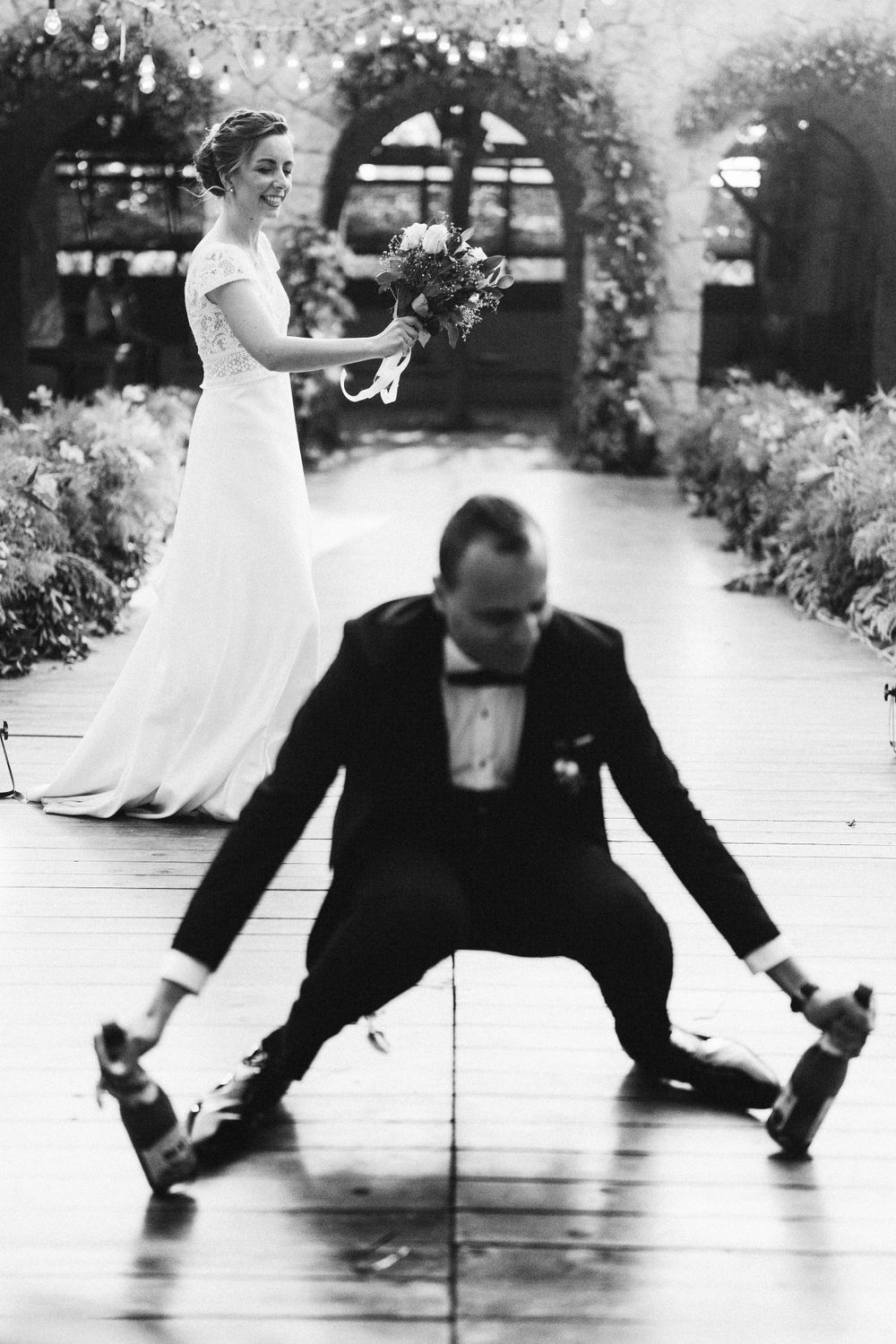 Black and white sequence of dancing couple performing dramatic moves on wooden floor.