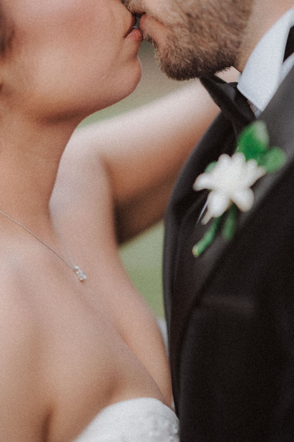Close-up wedding portrait showing tender intimate moment with delicate jewelry details.