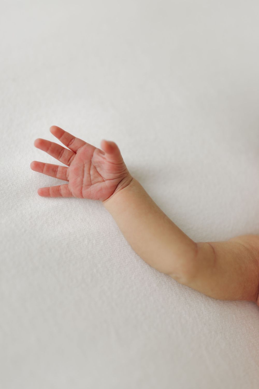 A sequence of hand gestures showing fingers gradually spreading open against a white background.