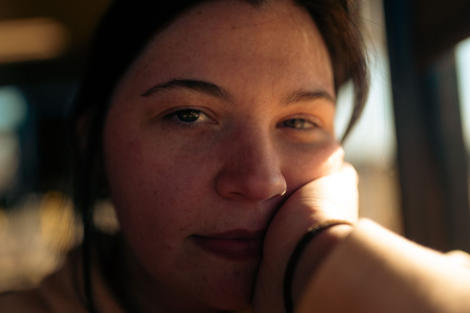 A series of close-up portraits in warm lighting showing different facial expressions and emotions.