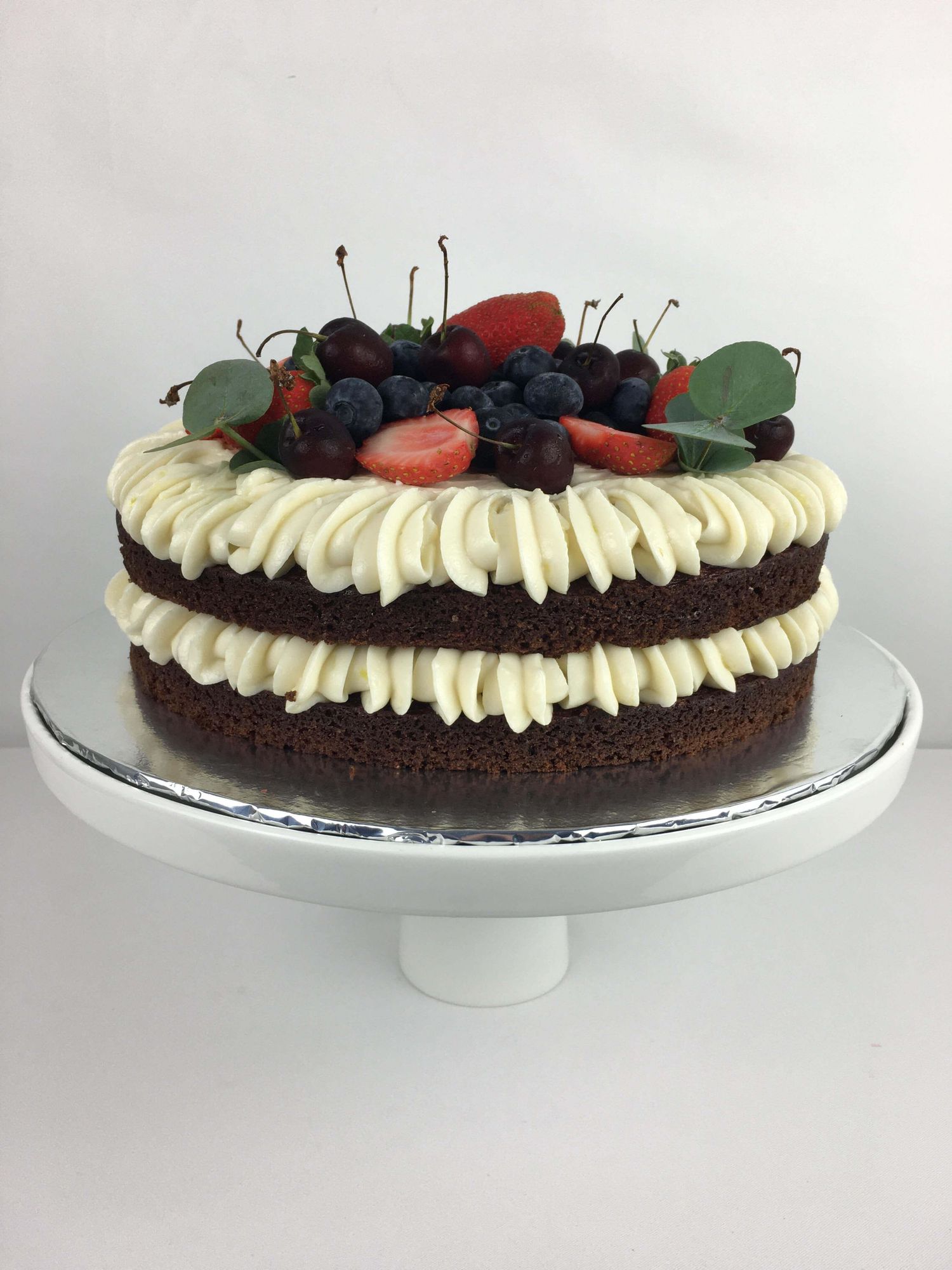 Flourish Bakery Howick – chocolate cake with creamy frosting and fresh berries, baked and delivered as a special gift.