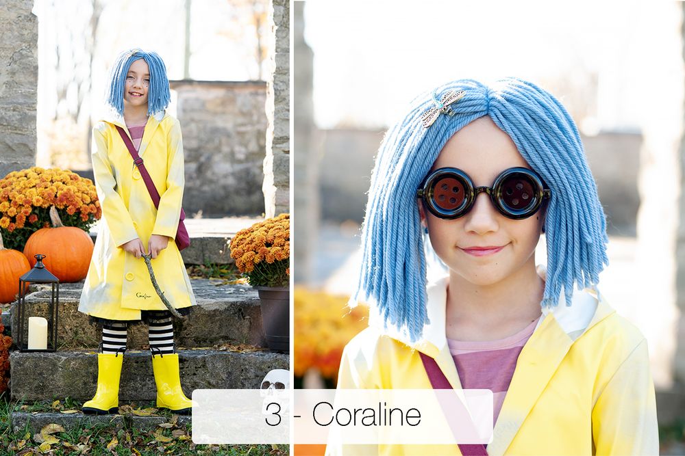 Child in a Coraline Halloween costume with blue yarn wig, yellow raincoat, striped tights and yellow boots, posed near pumpkins and mums.