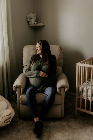 Expecting Mom during Lifestyle Maternity Photoshoot in Fort Wayne Indiana in home at Christmas time