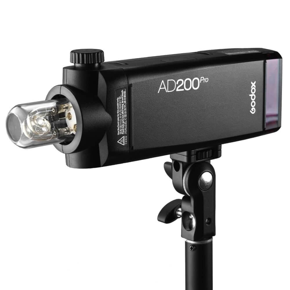 Godox AD200Pro portable flash strobe mounted on a light stand with bare bulb head attachment.