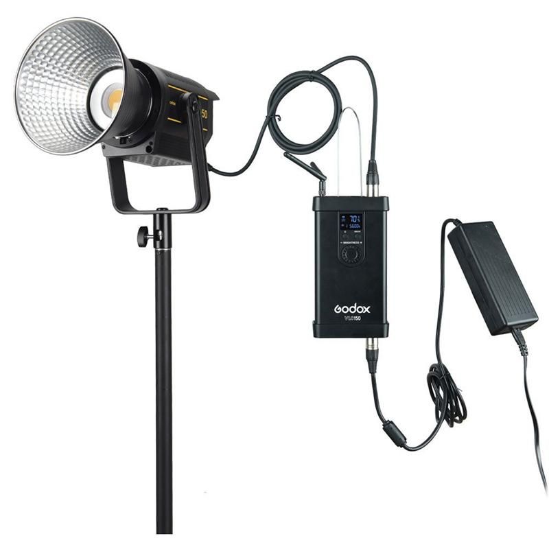 Godox COB LED video light with power supply unit and AC adapter on a light stand for photography.