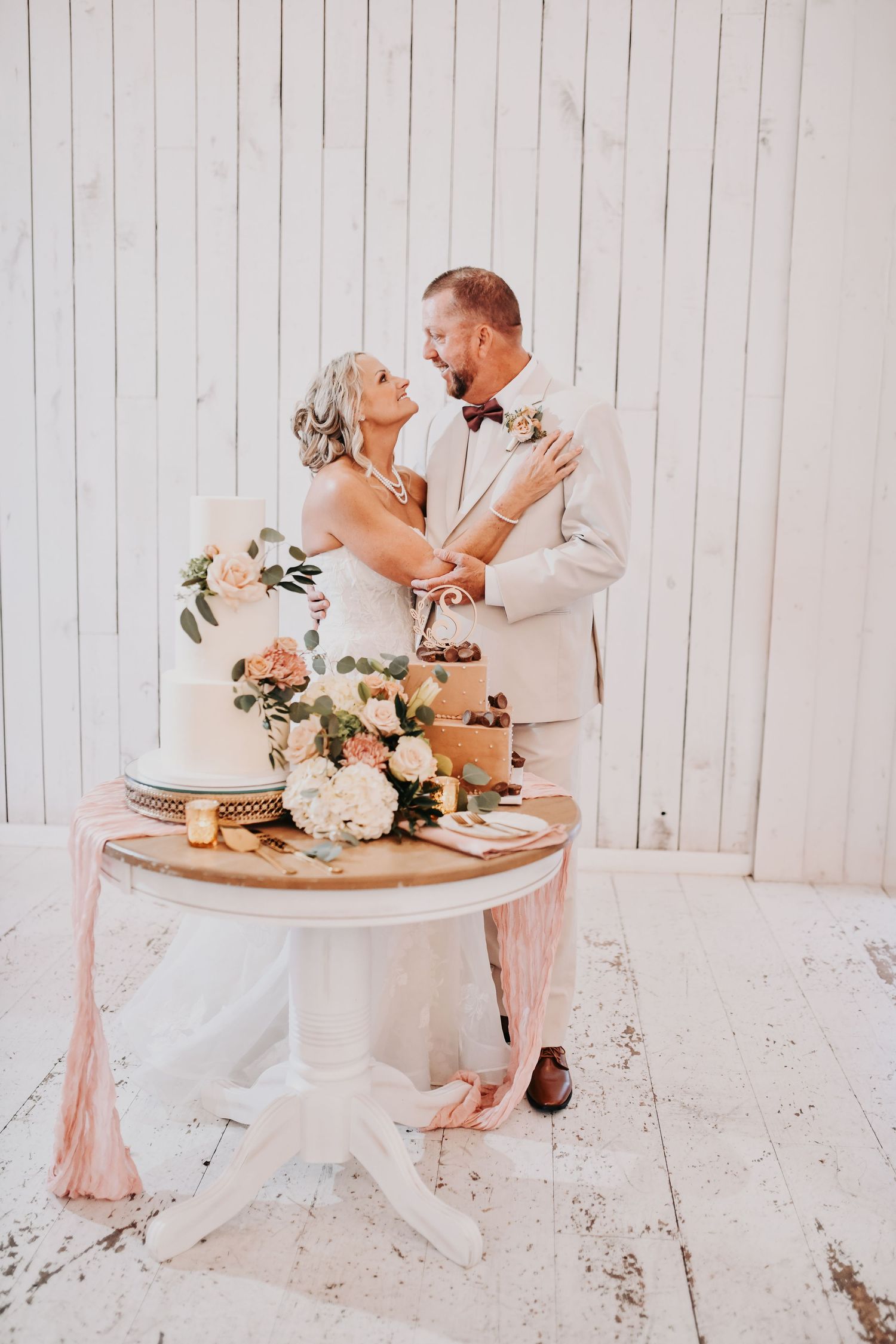 Romantic floral wedding cake displayed at The White Sparrow reception