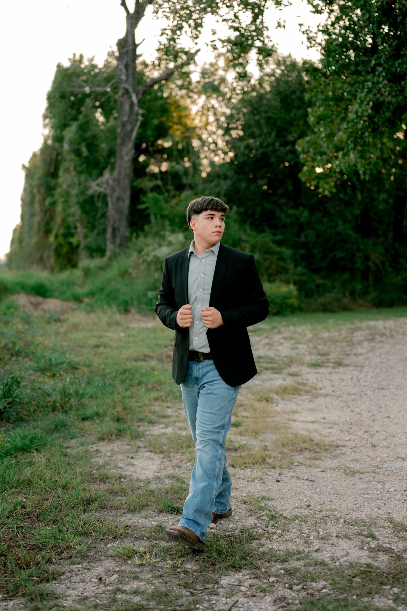 Houston high school senior guy posing outdoors for graduation portraits.