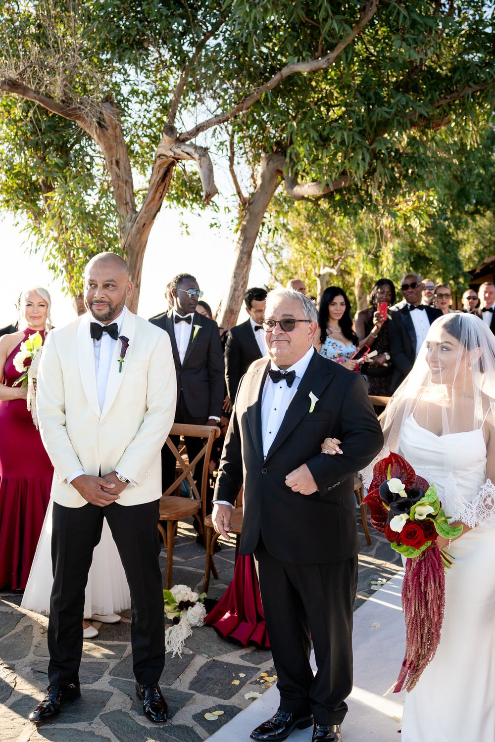 Newlyweds surrounded by their guests after the ceremony in Capo Vaticano