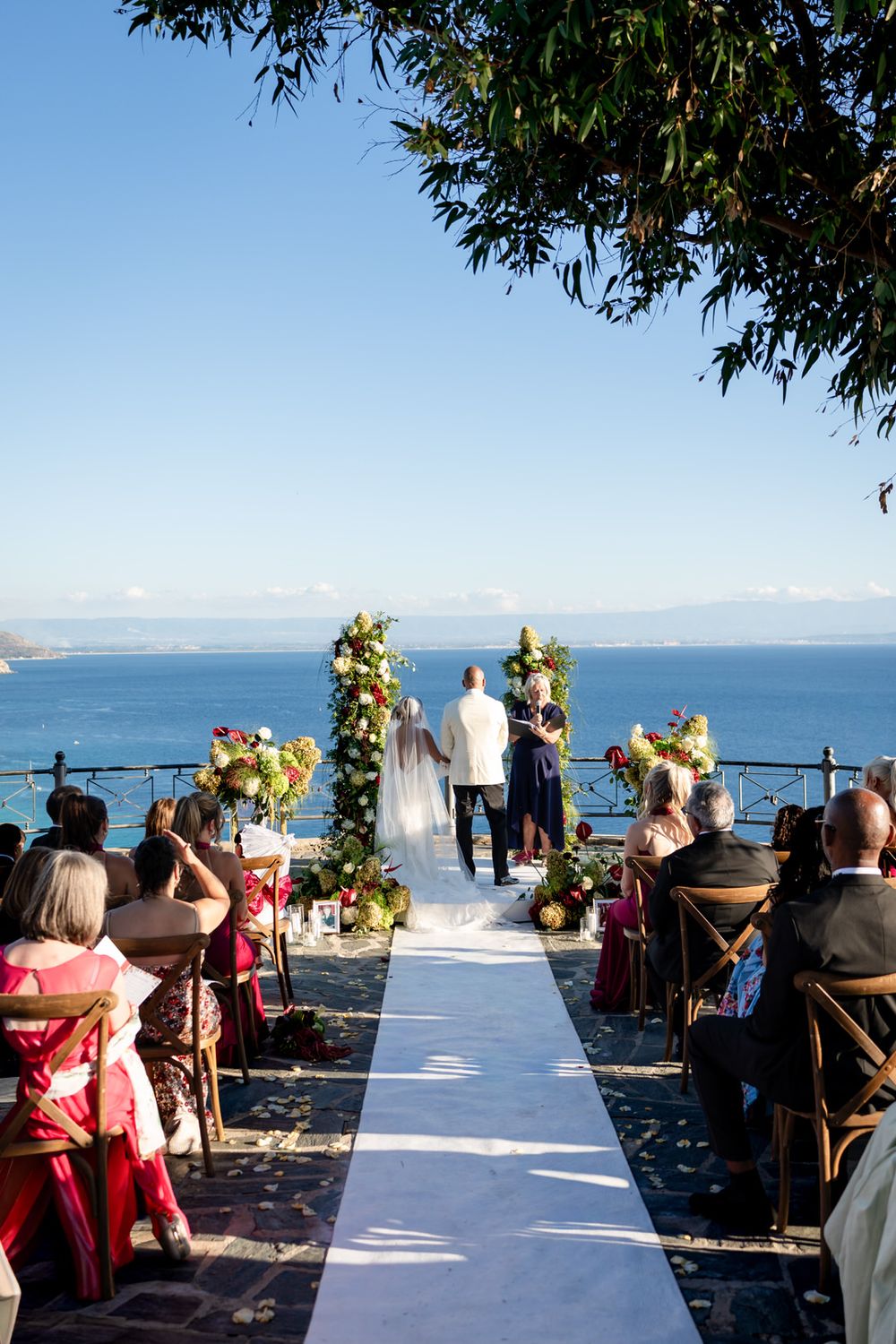 Bride and groom celebrating with guests after their wedding ceremony in Calabria