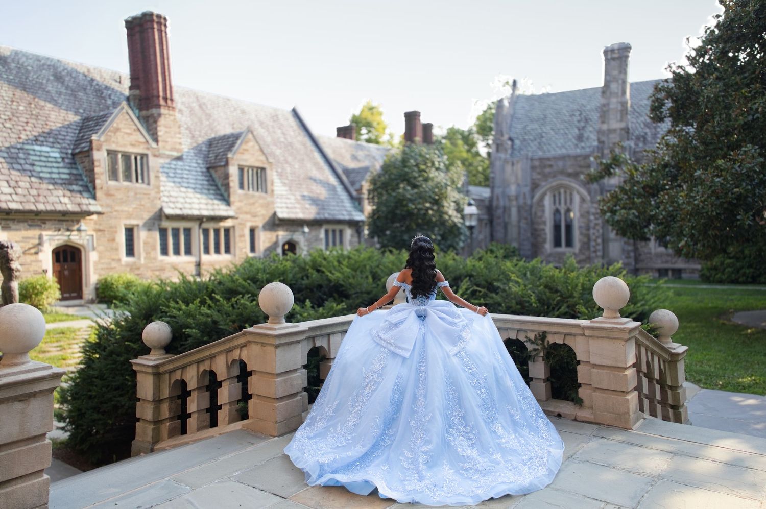 Quinceañera in a light blue ball gown on a stone terrace at Princeton, New Jersey quinceañera photos