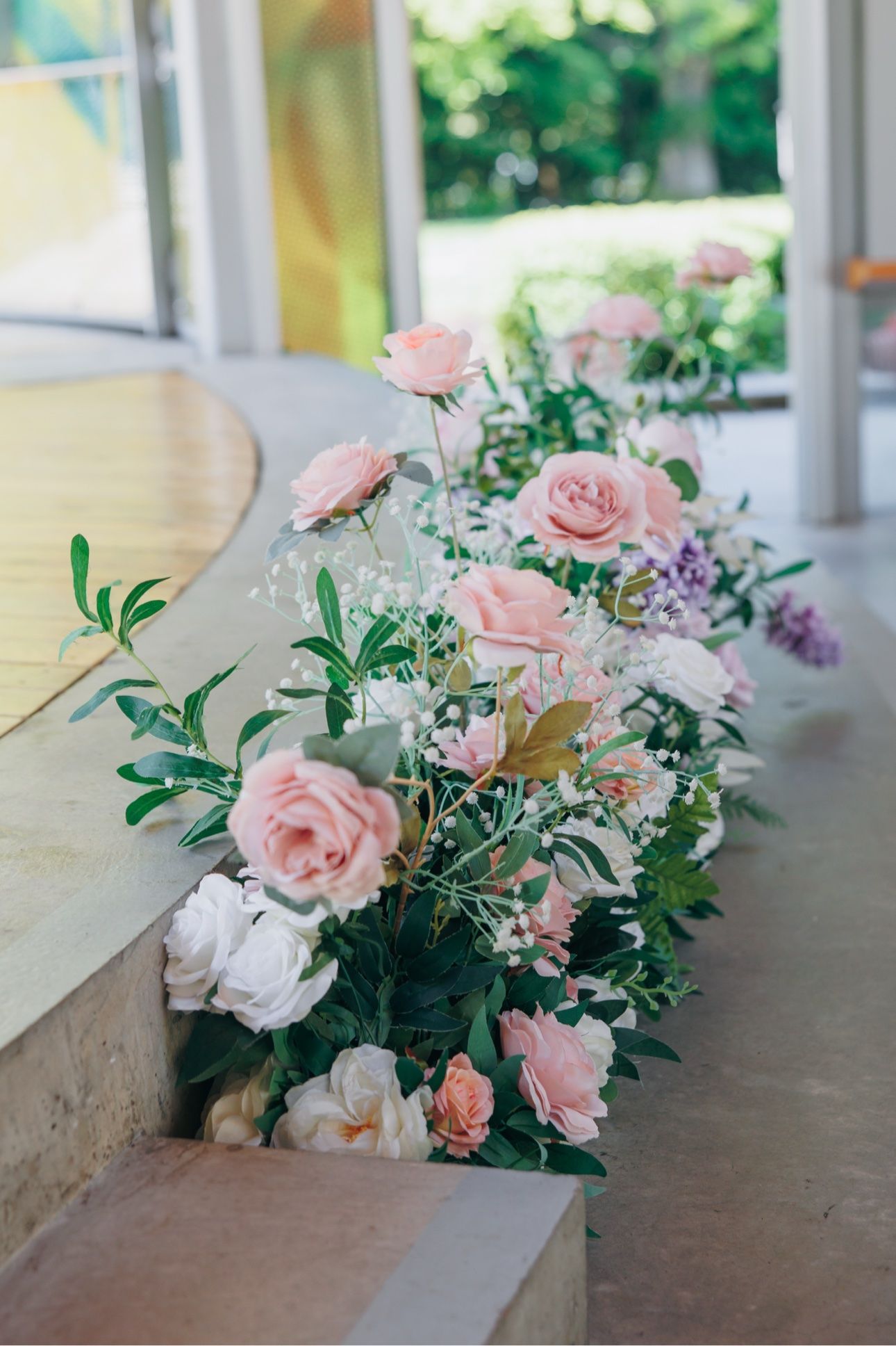 Blush and white floral arrangements lining the ceremony aisle at Celebration Pavilion, Queen Elizabeth Park wedding