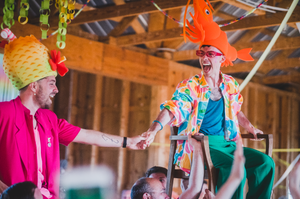 a queer couple performing the Hora dance on their wedding day