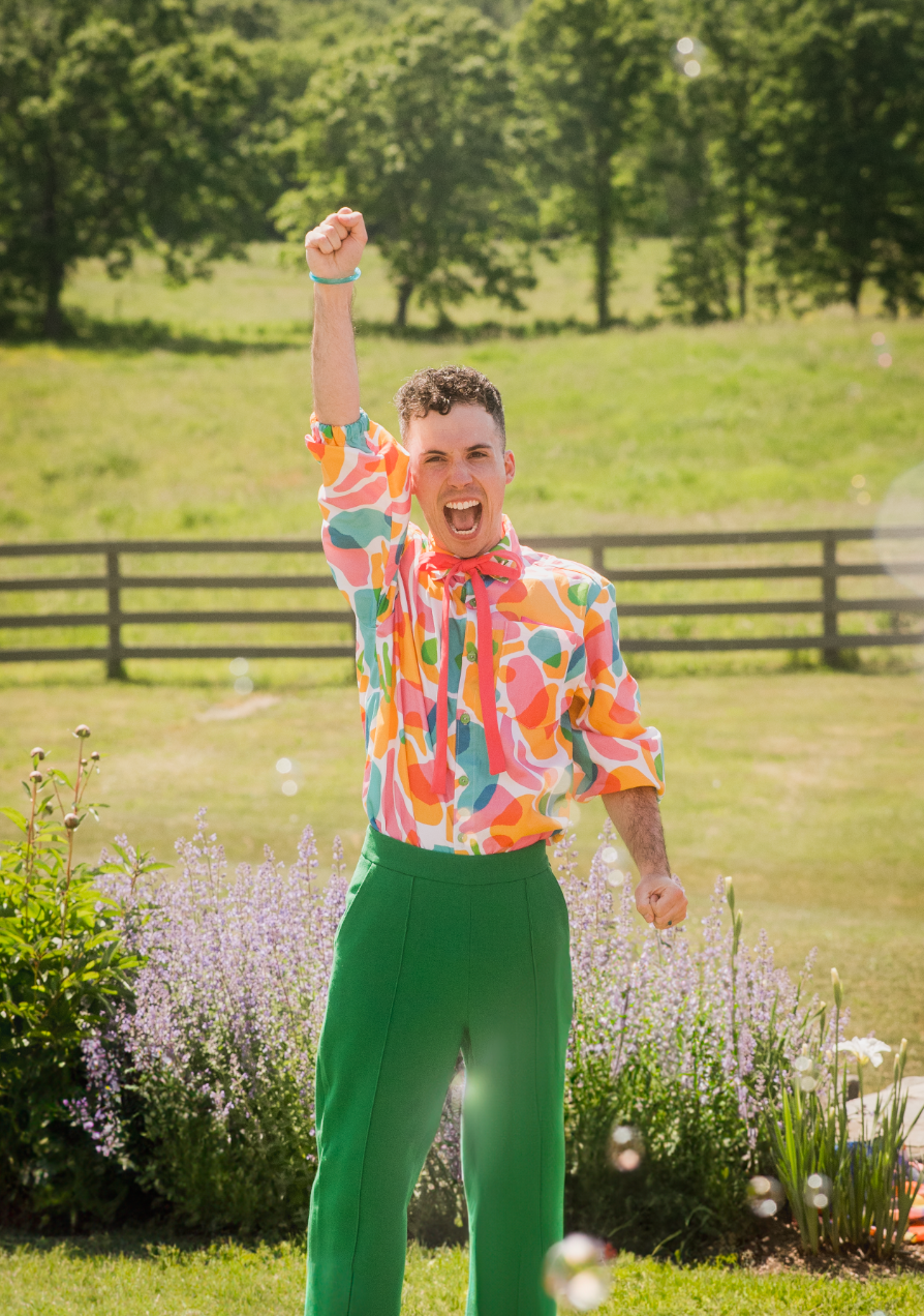 a young man cheering with his fist in the air after his wedding day