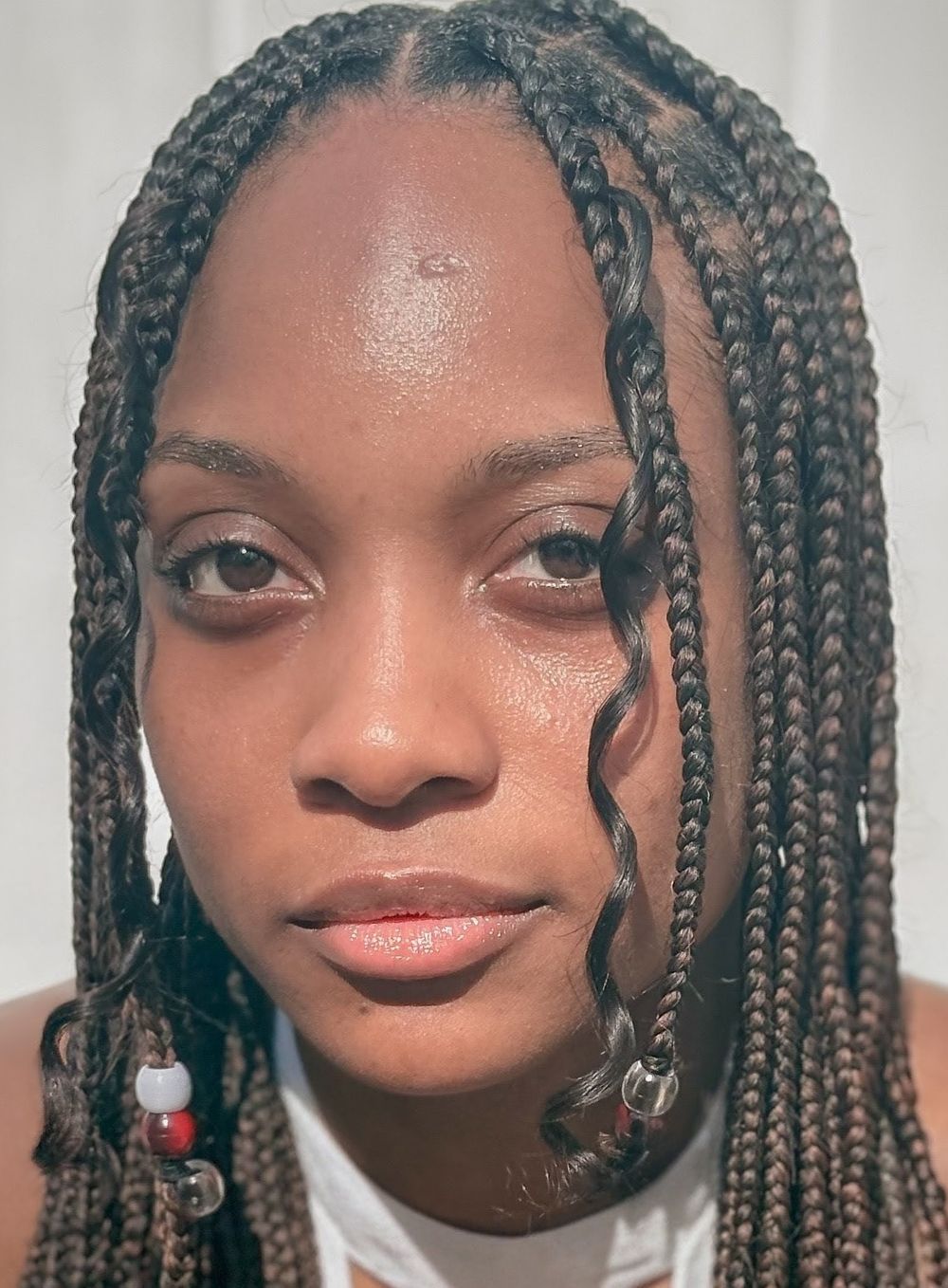 Close-up beauty portrait of Genesis Dudley with braided hair.