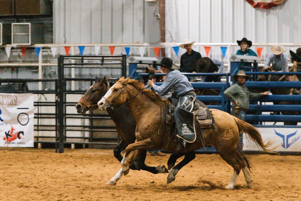 A cowboy catches a runaway horse at a ranch rodeo in Ada, Oklahoma.