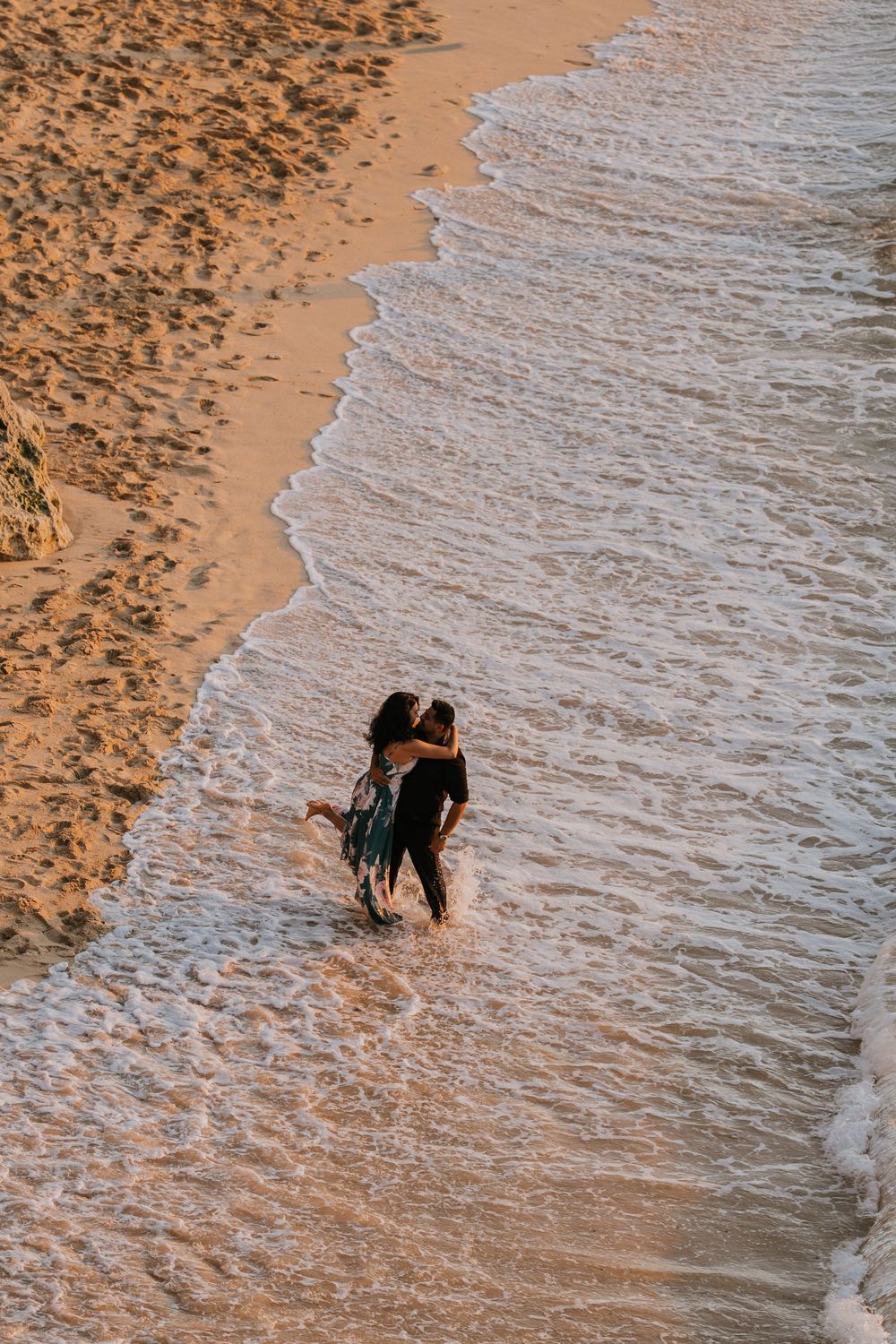 Romantic couple photoshoot at Balangan Beach Bali during golden hour.