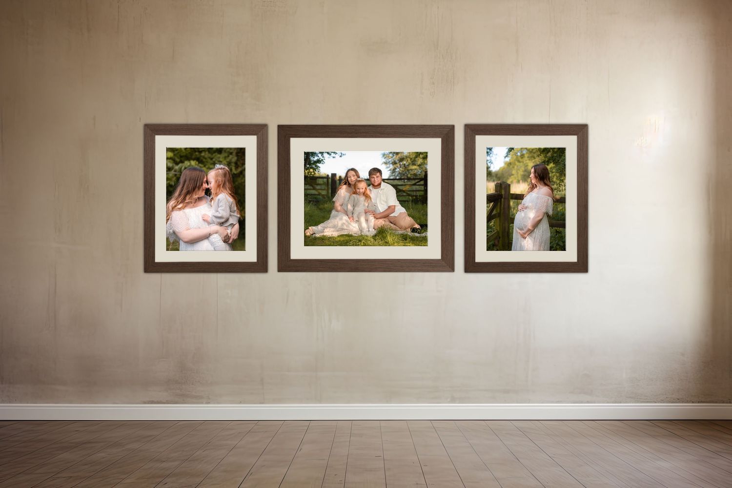 Three framed family portrait photos displayed on a beige wall, featuring outdoor maternity and family photography sessions.
