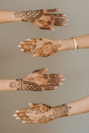 Intricate henna designs adorning hands in traditional Indian bridal mehndi patterns.
