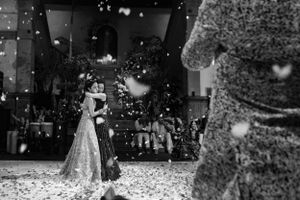 Black and white wedding celebration with confetti falling in the air.
