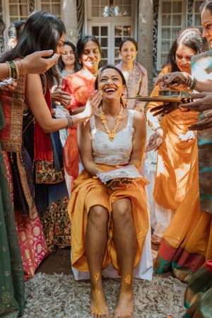 Joyful celebration with guests in colorful attire enjoying festivities outdoors.