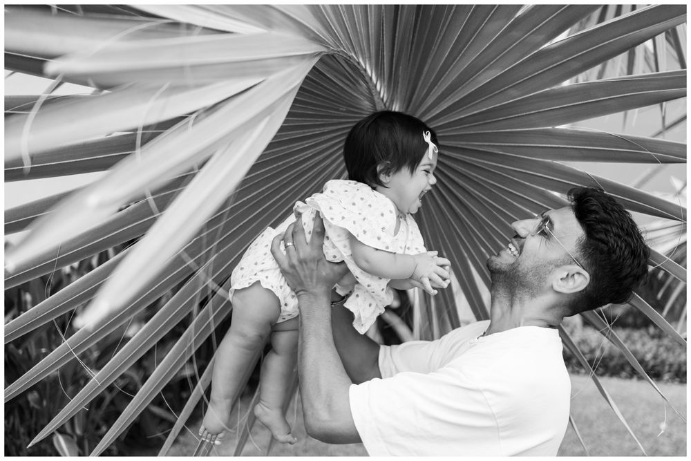 Father lifting his daughter above the shoreline during a beach family session near Sayulita.
