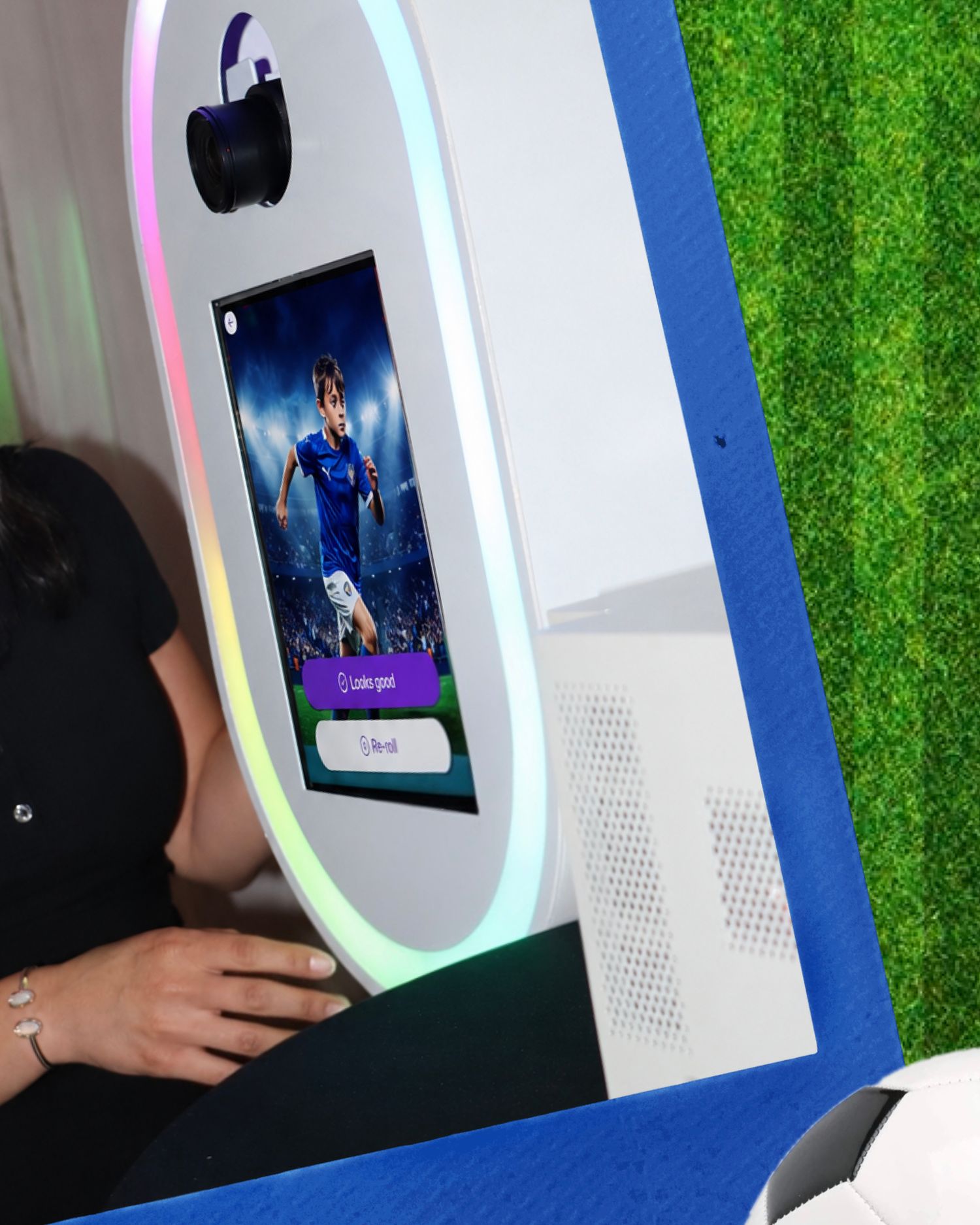 Interactive soccer-themed photo booth kiosk with RGB lighting and touchscreen display showing a football player.