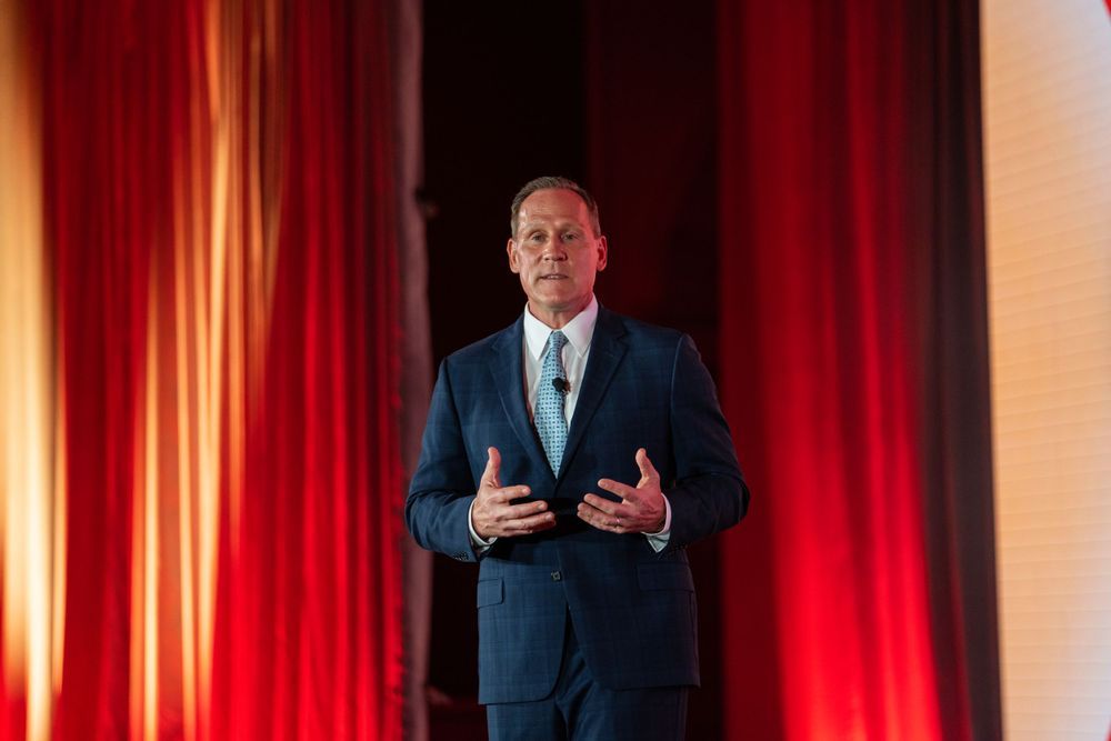 Orlando corporate event photographer — keynote speaker on stage at professional conference