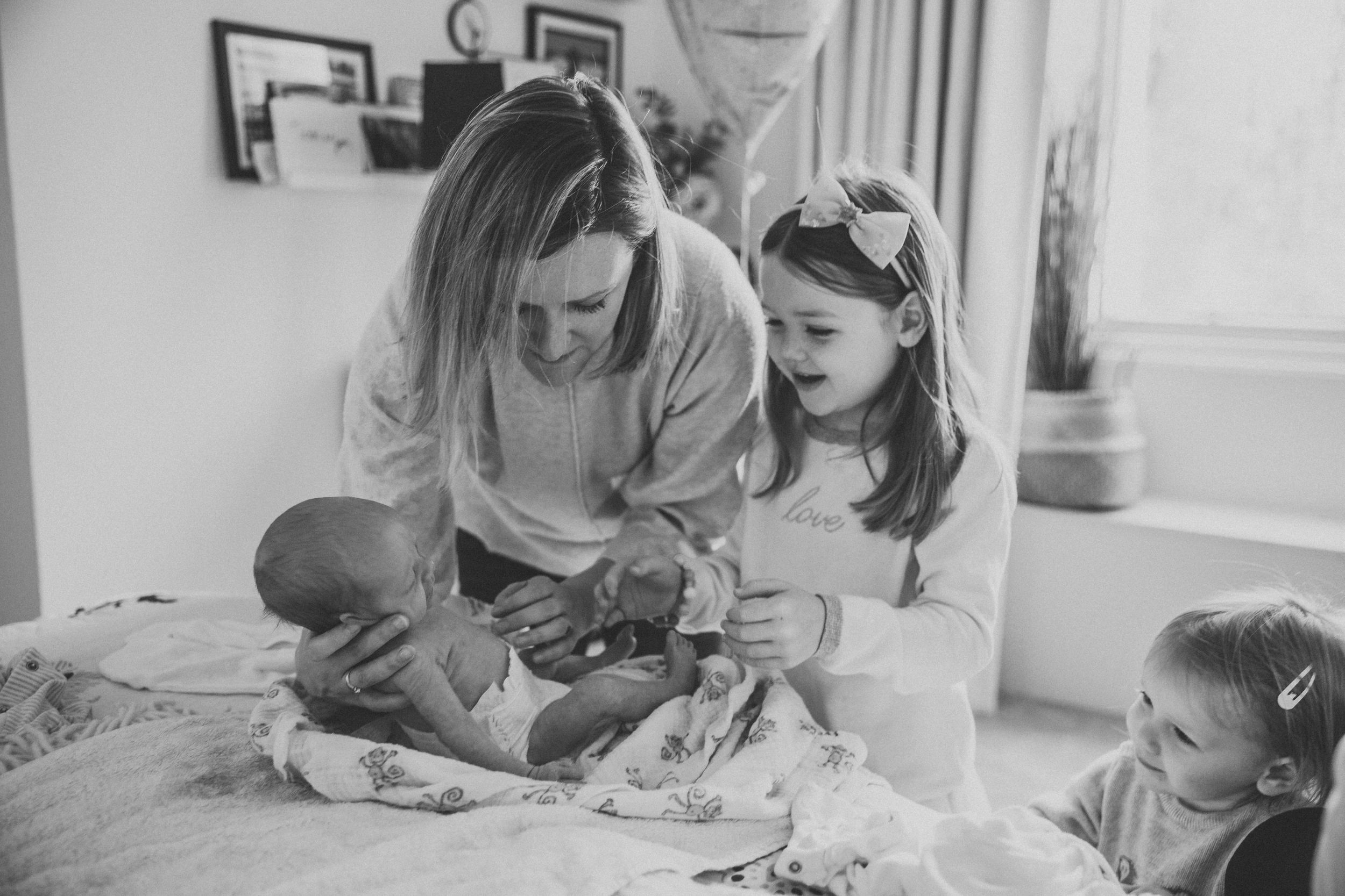 A family gathering on the bed involves craft activities and bonding time together.