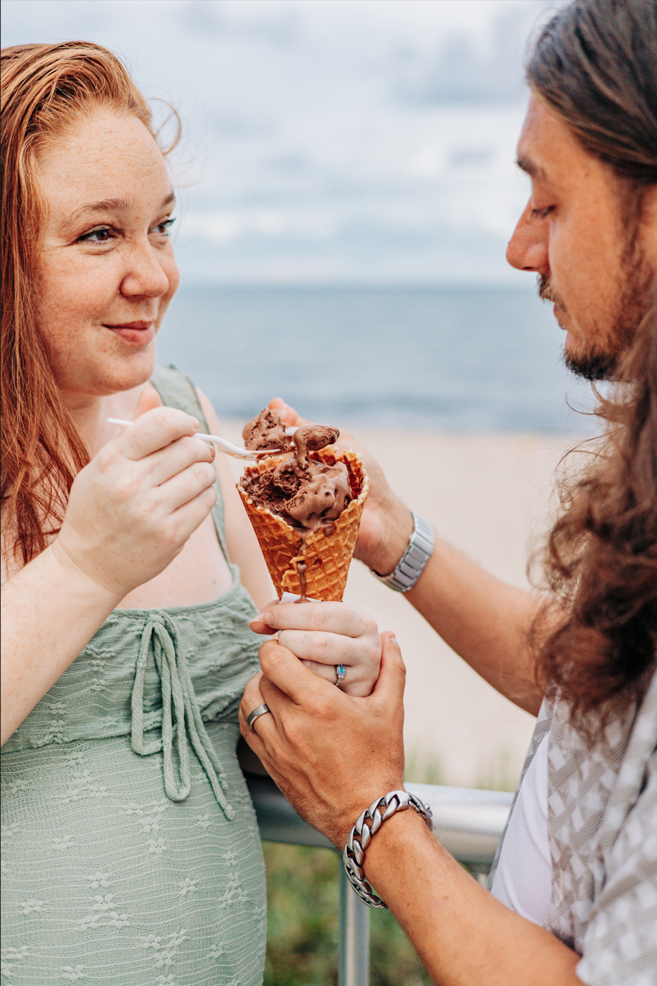 Maternity photoshoot Lake Worth of an expecting couple sharing ice cream near Lake Worth Beach.