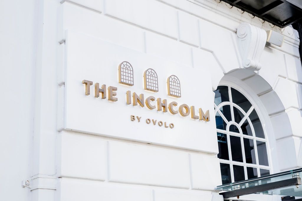 The Inchcolm by Ovolo hotel sign displayed on a white heritage building facade in Brisbane.