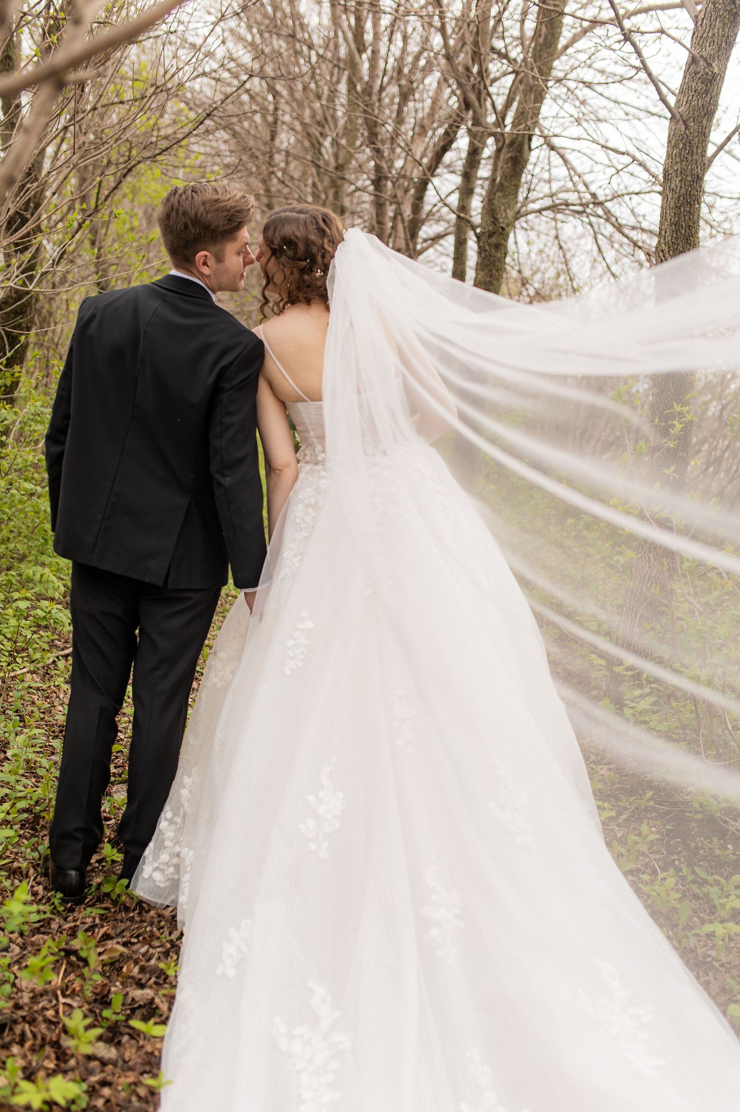 An emotional moment captured as two women share a tender moment in formal dresses, one in pink and one in white lace.  Starlit Point