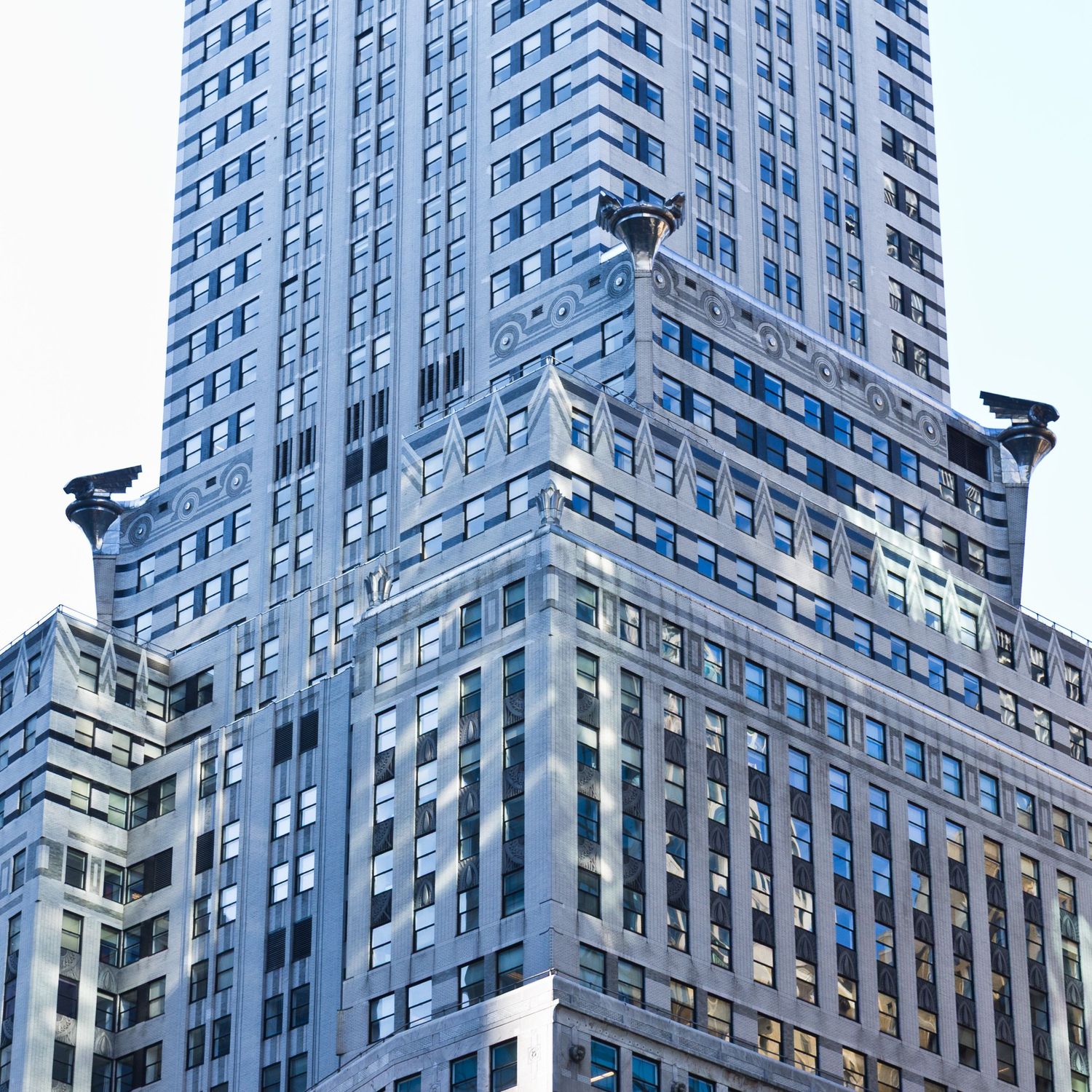 Close-up view of the Chrysler Building's iconic Art Deco architecture with eagle gargoyles and gleaming steel facade in NYC.