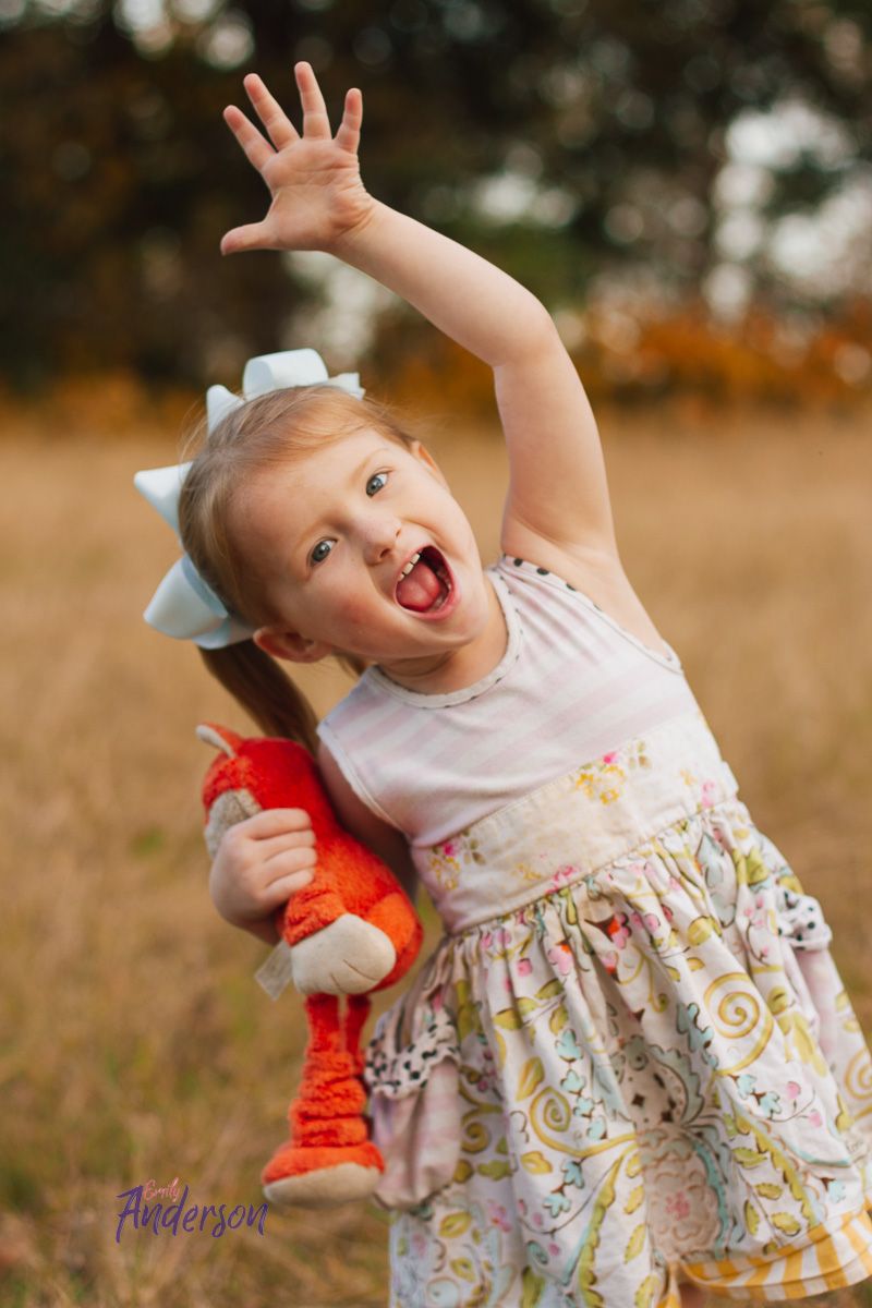 a little girl in a field during a fall childhood photography session in Manila Arkansas