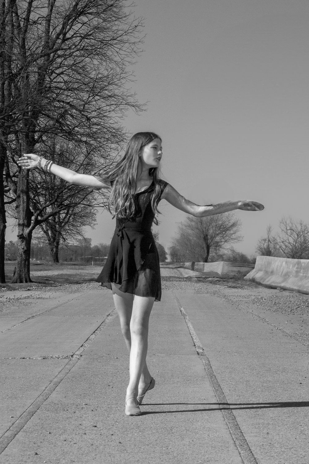 a teen girl dancing on a rural bridge in Mississippi County Arkansas