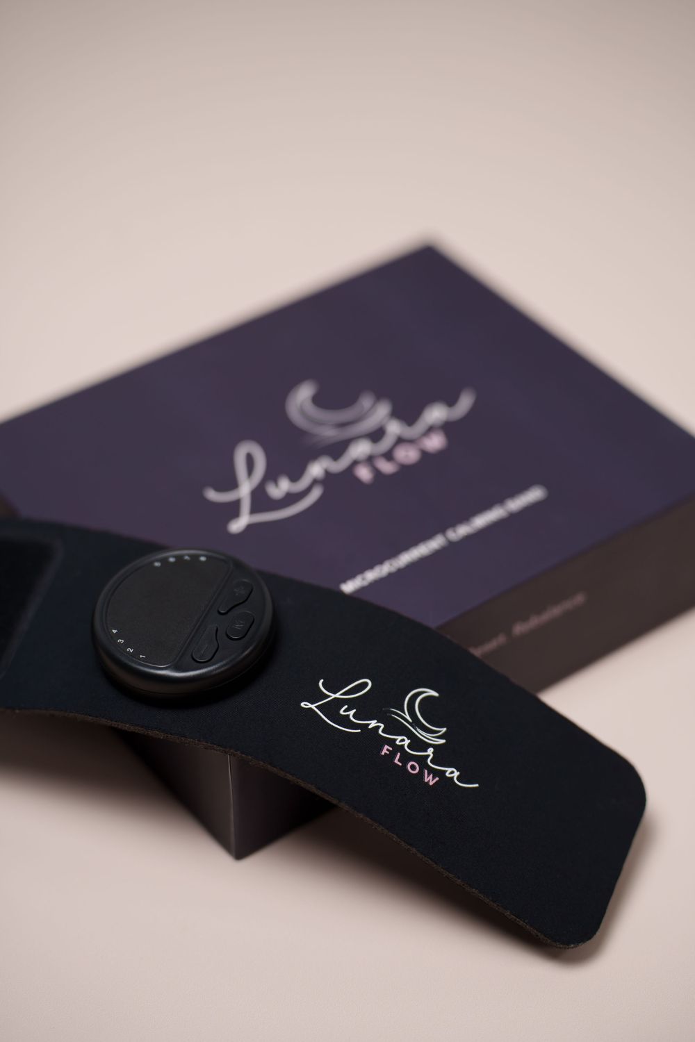 Lunar Flow branded cosmetic palette and compact displayed against a purple box on a beige background.