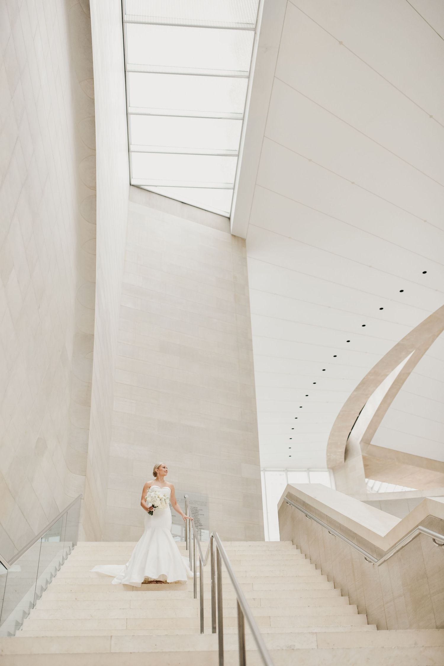 Bride posing on the grand staircase at the Meyerson Symphony Center in Dallas