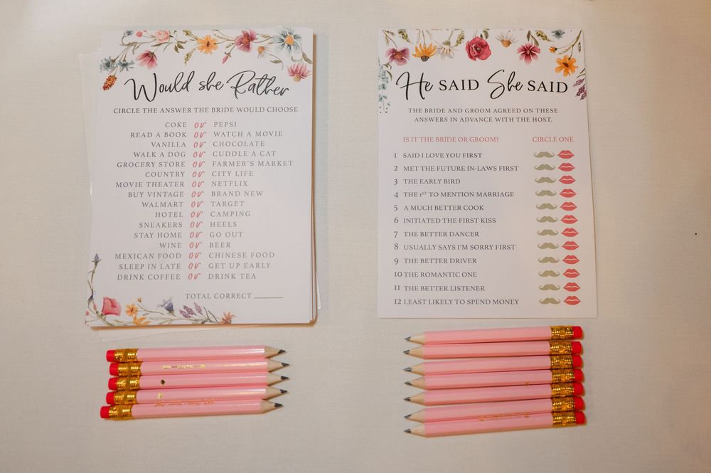 Floral bridal shower games including Would She Rather and He Said She Said cards with pink pencils.