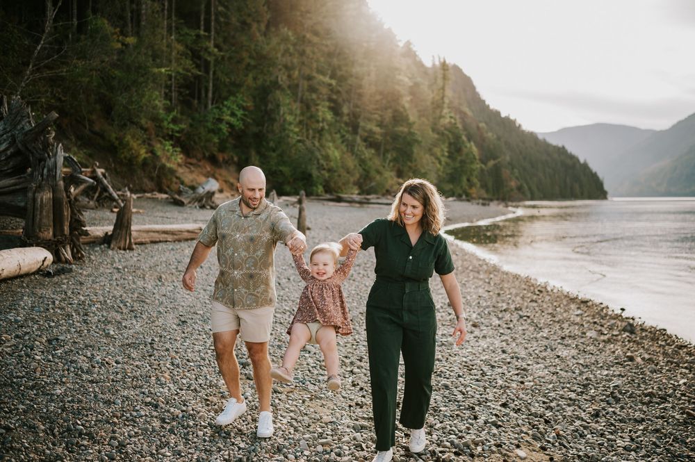 Comox Valley Photographer Portraits at Comox Lake in Cumberland, Vancouver Island. Family holding hands swinging kid