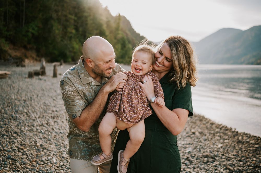 Comox Valley Photographer Portraits at Comox Lake in Cumberland, Vancouver Island. Family holding and tickling kid