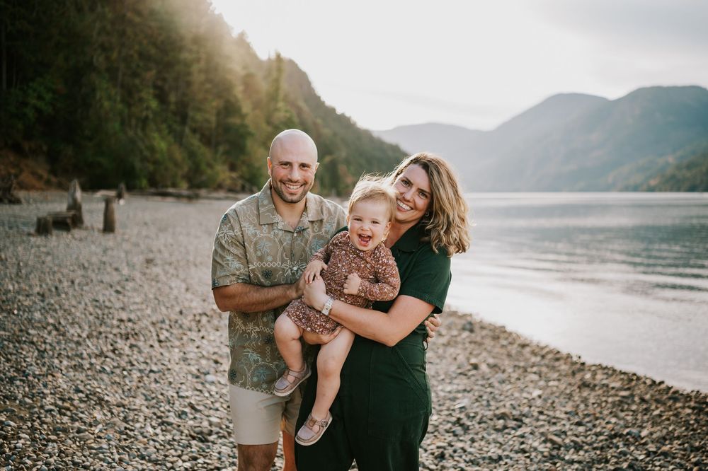Comox Valley Photographer Portraits at Comox Lake in Cumberland, Vancouver Island. Family holding and tickling kid