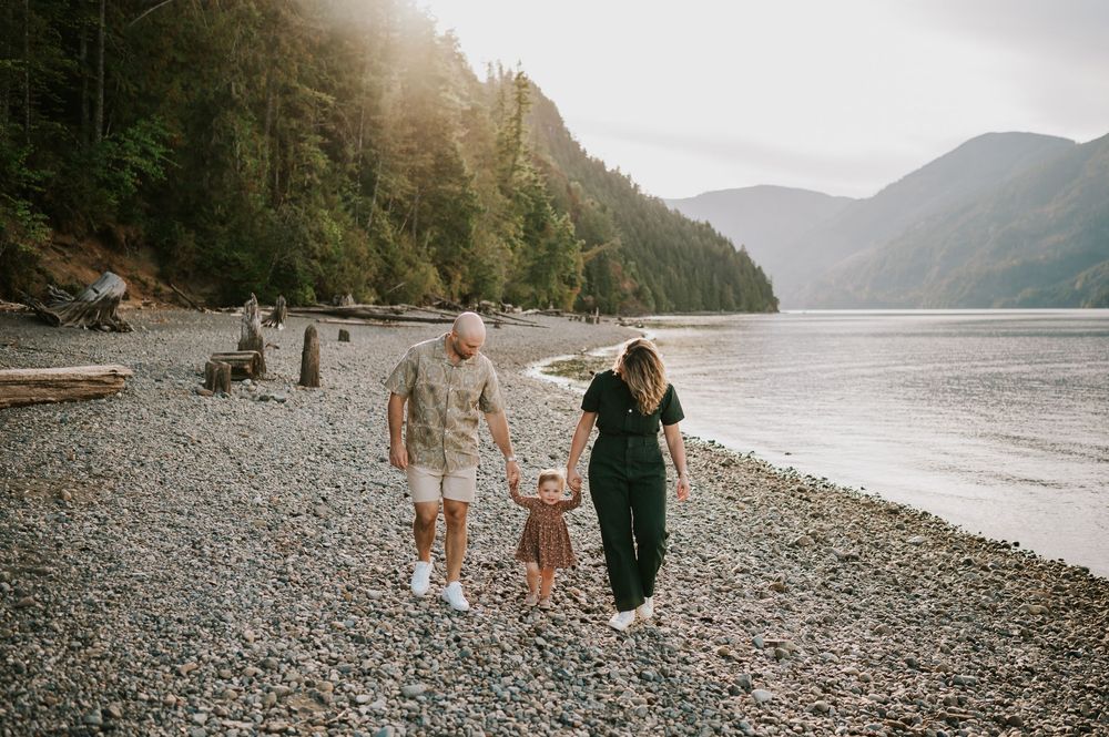 Comox Valley Photographer Portraits at Comox Lake in Cumberland, Vancouver Island. Family holding hands swinging kid