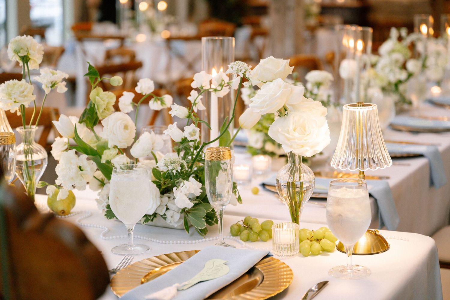 White, blue and green reception table scape at Historic Hill House wedding venue in Willis Texas.