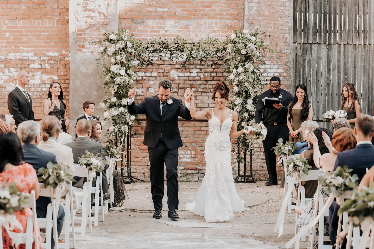 Megan and Joel walking back down the aisle as newlyweds