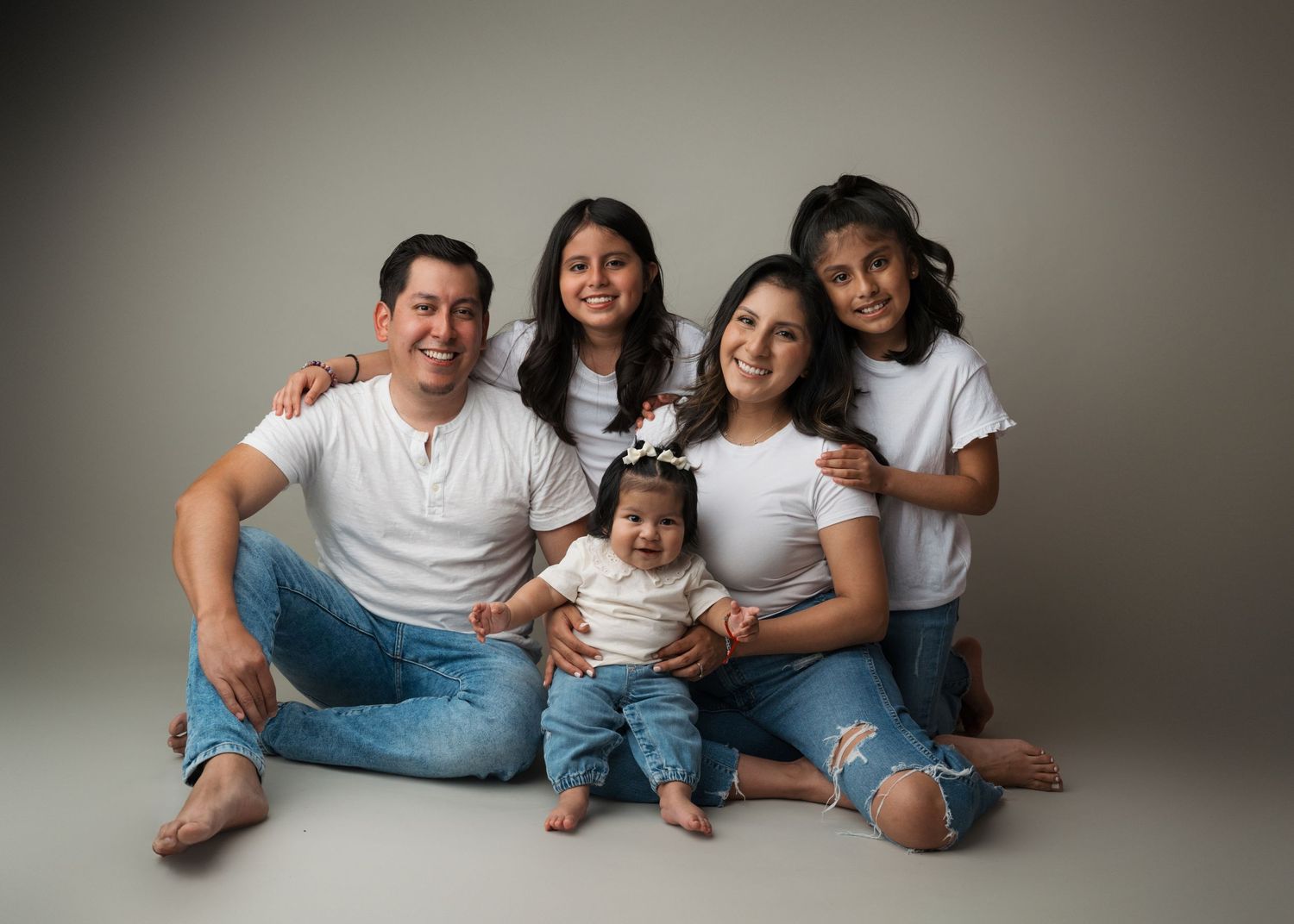 Family of five posing together during a studio family photography session in Linden, New Jersey.