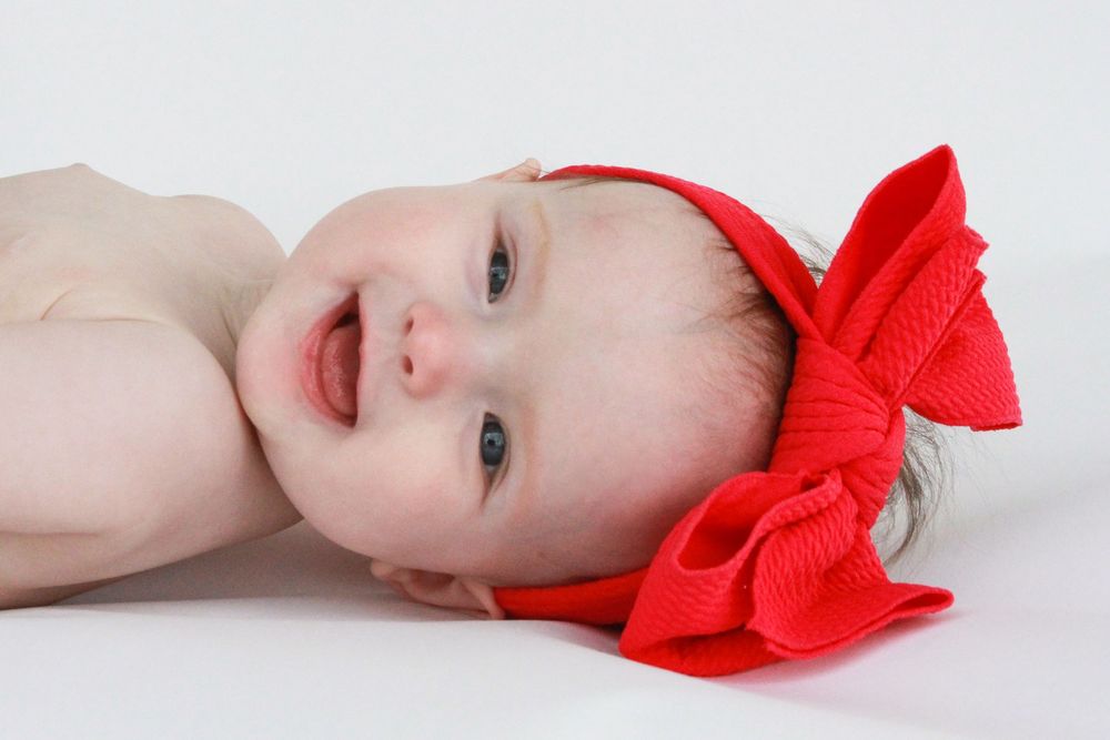 Smiling infant photographed by Delta Blossoms Photography