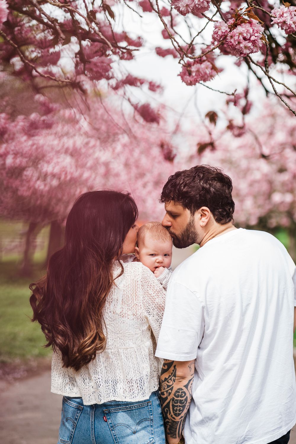 Family photography at Dawson park Dundee during blossom season with mum, dad and baby