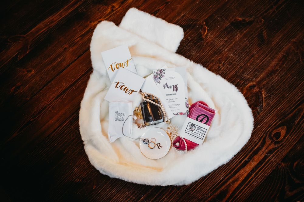 White fuzzy toiletry bag containing beauty products and skincare items arranged on dark wooden surface.