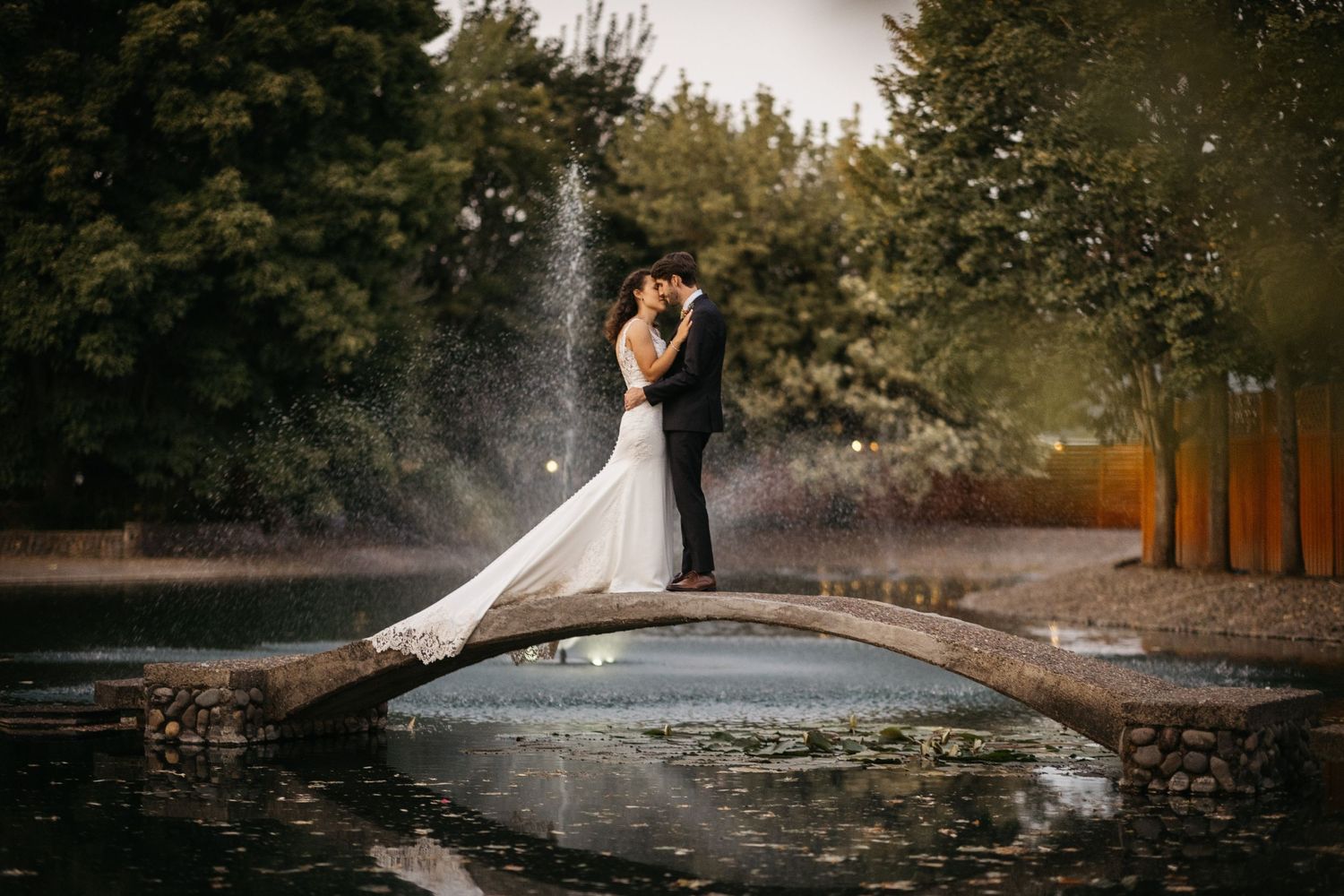 Bride and Groom on bridge in front of fountain at The Water Oasis in Newberg, Oregon