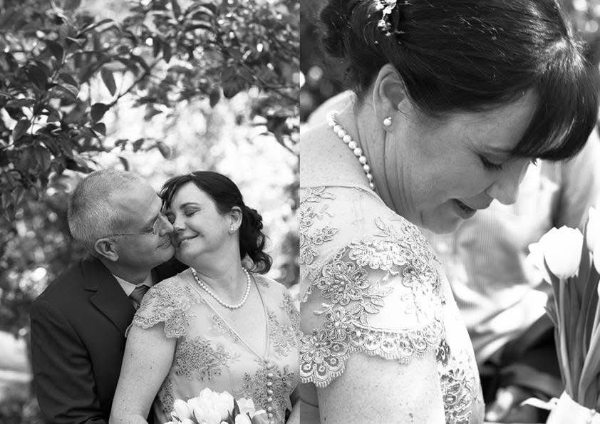 Black and white wedding photo of groom kissing bride on cheek during ceremony.